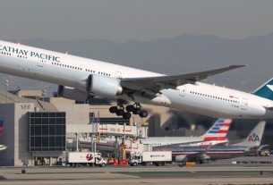 Cathay Pacific sees continued pressure from HK travel restrictions